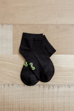 Load image into Gallery viewer, A pair of ankle length black Sensory Friendly Clothing Seamless Feel Socks with the non irritating logo exposed on the sole.