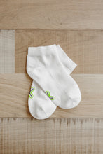 Load image into Gallery viewer, A pair of ankle length white Sensory Friendly Clothing Seamless Feel Socks with the non irritating logo exposed on the sole.