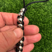 Load image into Gallery viewer, Kaiko Caterpillar Fidget being held in a hand with thumb rolling up it.