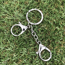 Load image into Gallery viewer, Kaiko Fidget Clip placed on green grass.