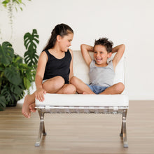 Load image into Gallery viewer, A girl and boy sit on a chair together.  The girl is wearing a black Sensory Friendly Clothing singlet and the boy wears a grey marle Sensory Friendly Clothing singlet.  Both are smiling and look relaxed and calm.

