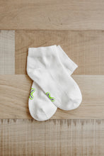 Load image into Gallery viewer, A pair of ankle length white Sensory Friendly Clothing Seamless Feel Socks with the non irritating logo exposed on the sole.
