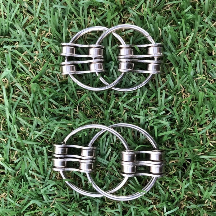 Two Kaiko LOOP Double Fidgets placed on grass.